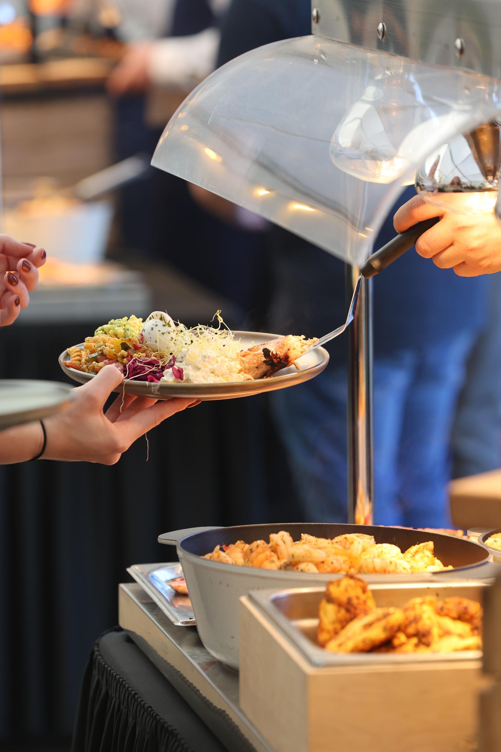 Guest being served food at a buffet station